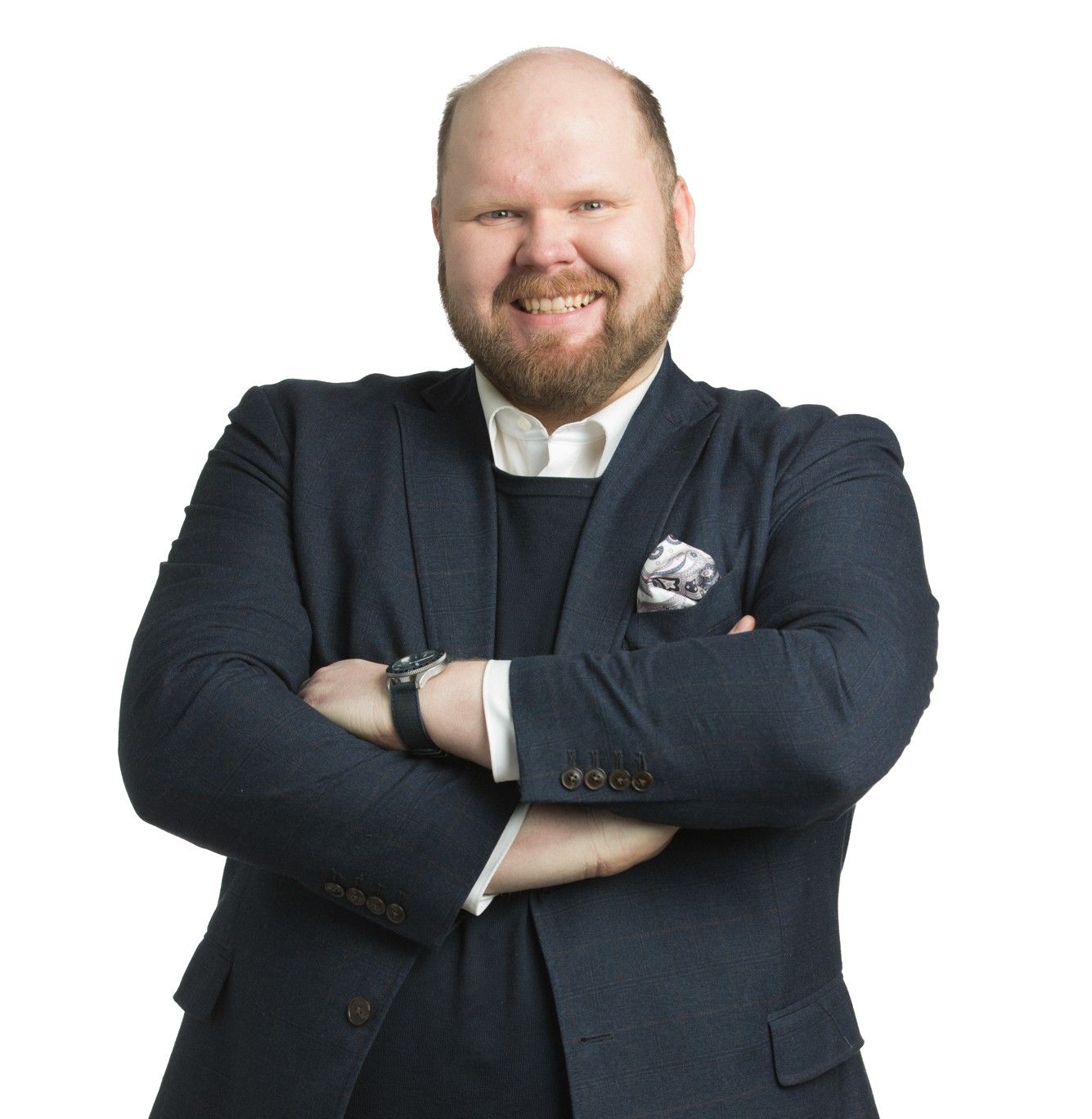 Antti Brunni in a dark blazer with arms crossed against a white background.